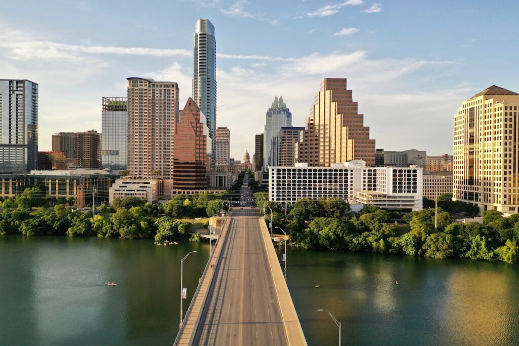 Austin skyline with a large bridge over water.