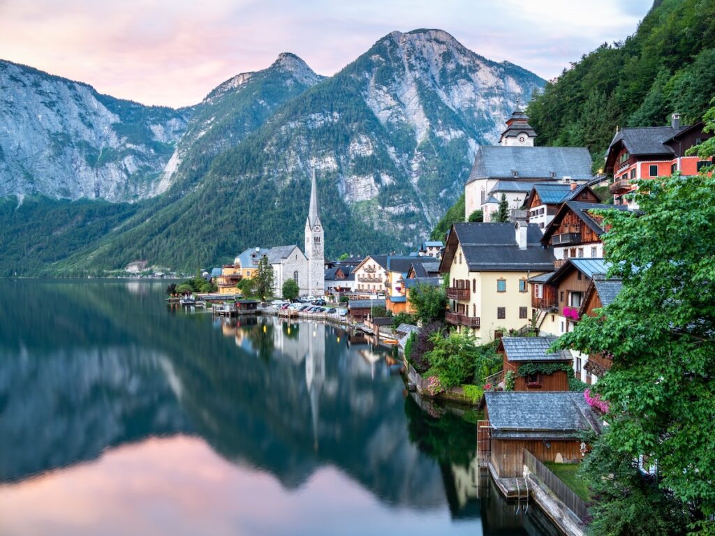 Austria coastline with buildings and mountains in the background.