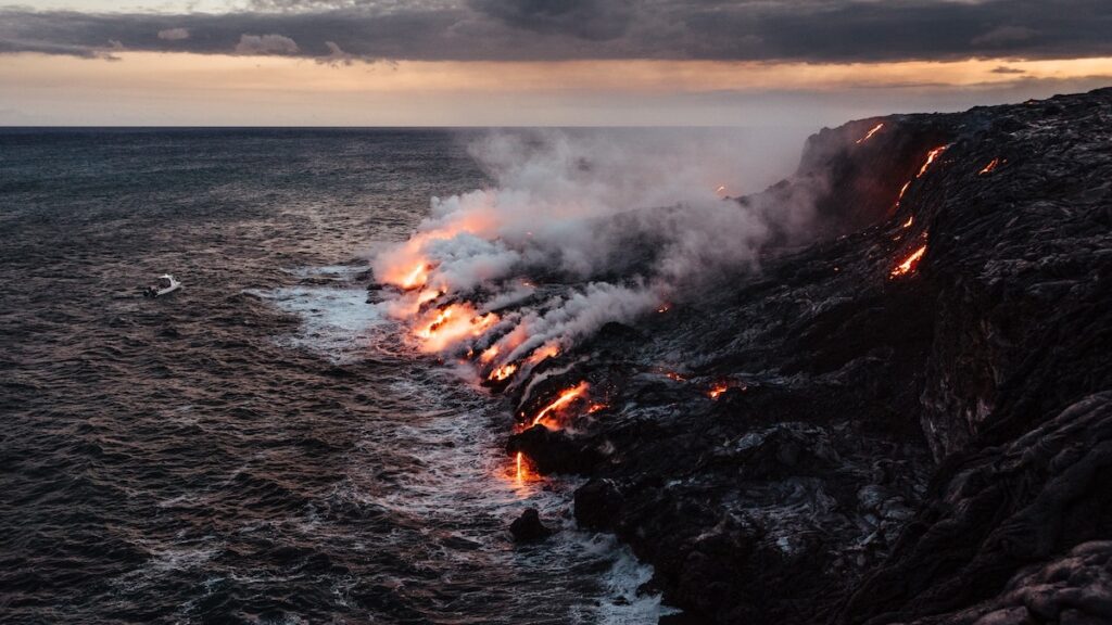 Lava flowing into the ocean from a volcano.