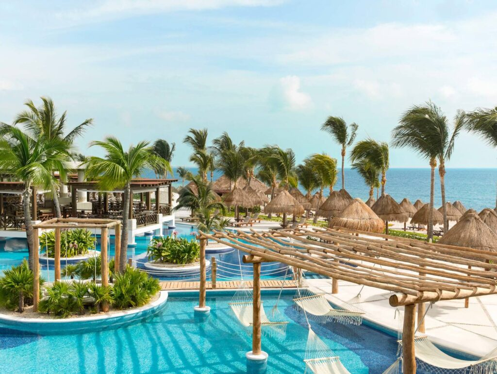Pool at Le Blanc Spa Resort Los Cabos with pergolas and hammocks.